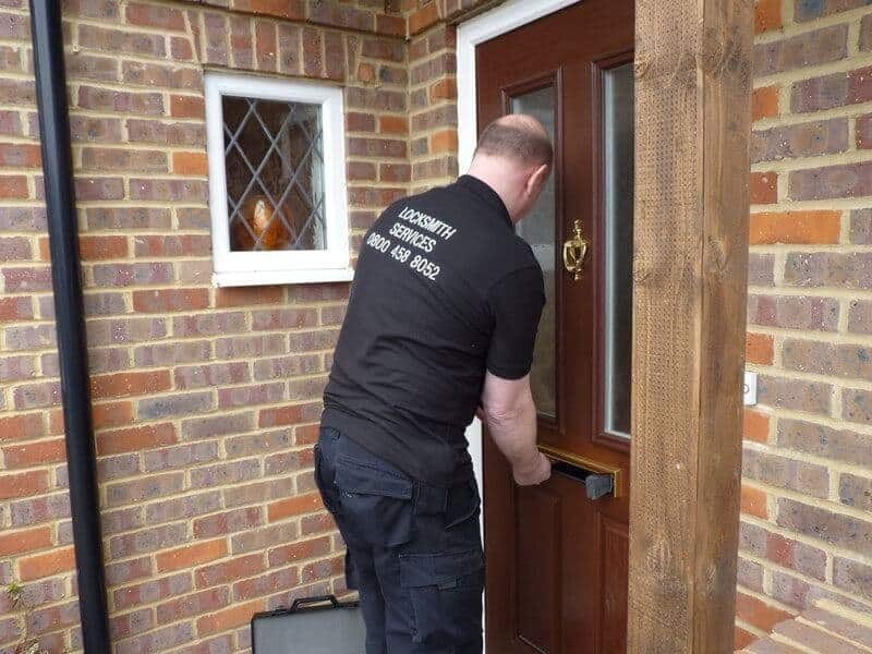 Locksmith working on unlocking a locked door